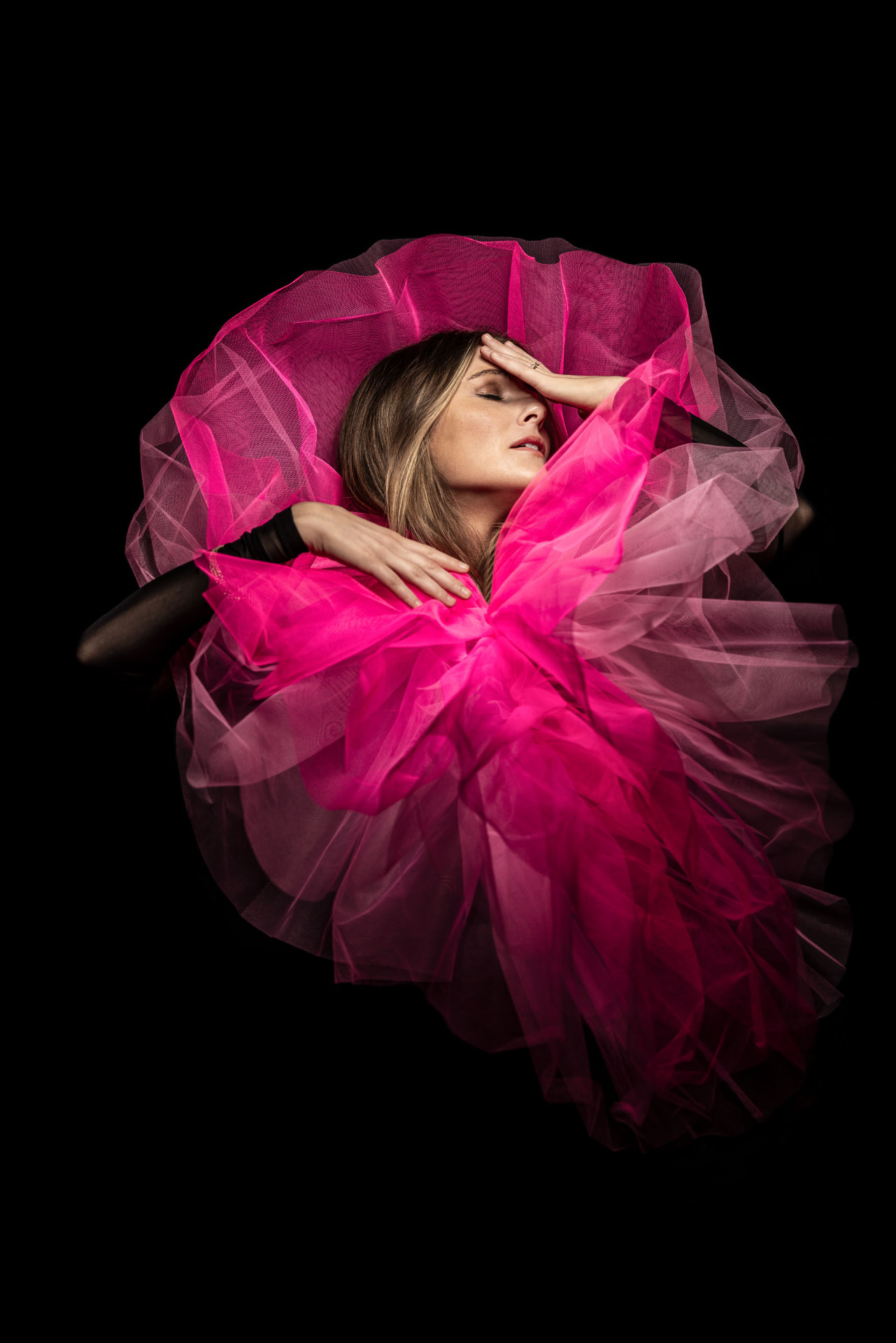 Ellinor Olmarken portrait in pink tulle, hand at forehead